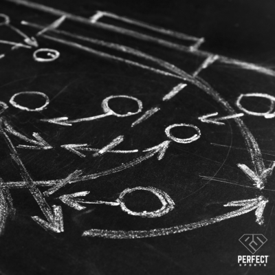 football playbook with chalk and arrows on black board